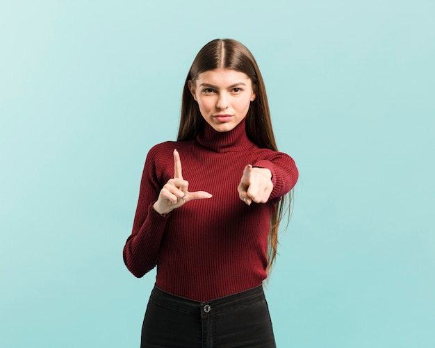 Front view pointing woman in studio