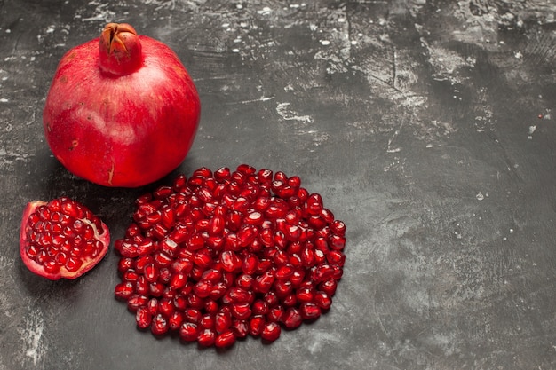 Front view pomegranate pomegranate seeds on dark table free space