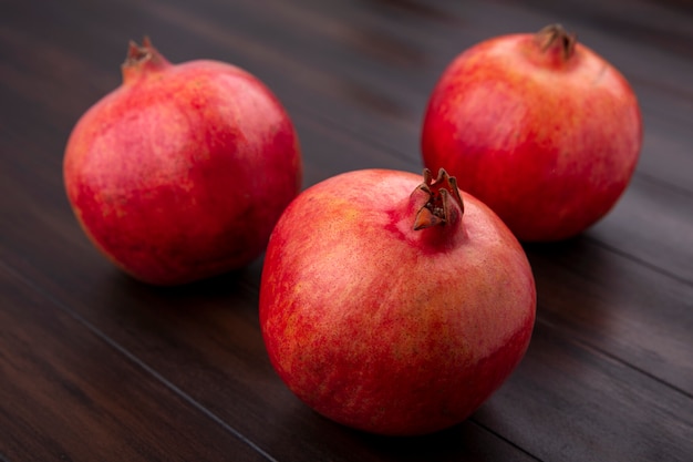 Front view of pomegranate on a wooden surface