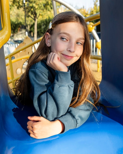 Foto gratuita ritratto di vista frontale di bella bambina al parco giochi