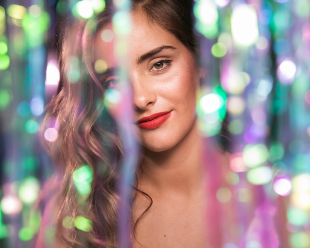 Free photo front view portrait of a girl and blurred sparkles effect