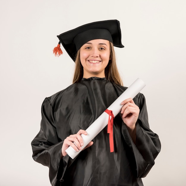 Front view portrait of young woman graduating