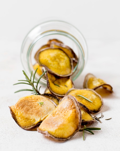 Front view of potato chips with rosemary in jar