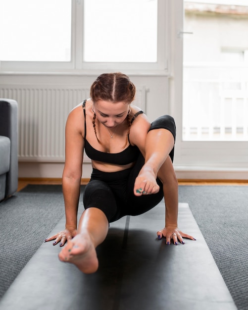 Front view practicing yoga at home concept