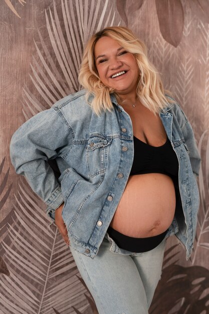 Front view pregnant woman posing in studio