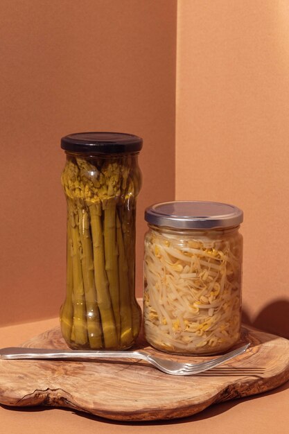 Front view preserved food in jars with fork