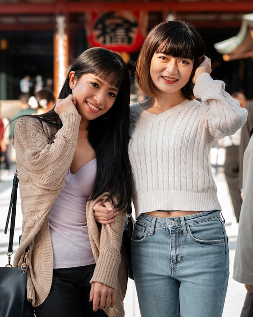 Free photo front view of pretty asian girls together