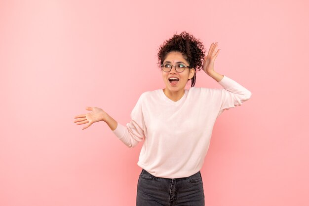 Front view of pretty female excited on pink