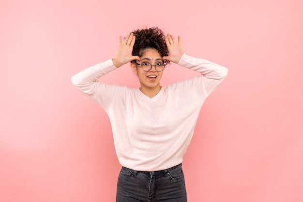 Front view of pretty female excited on pink