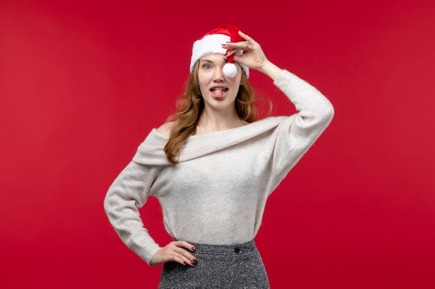 Front view of pretty female playing with red cap on red