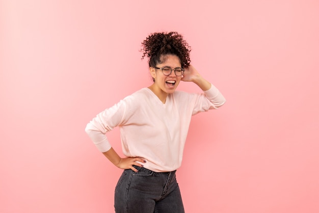 Front view of pretty female screaming on pink