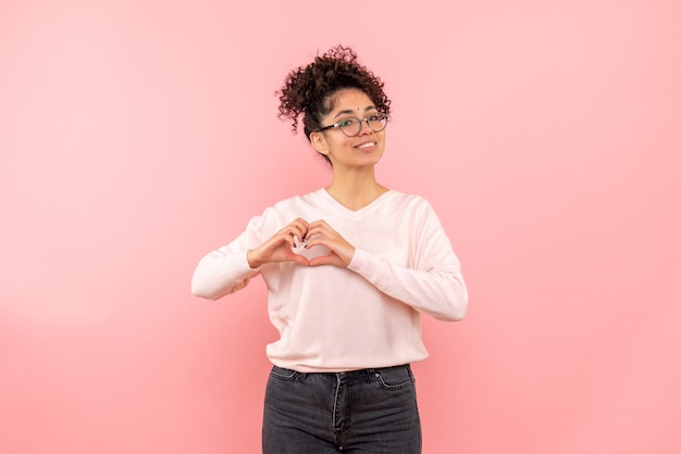 Free photo front view of pretty female sending love on pink