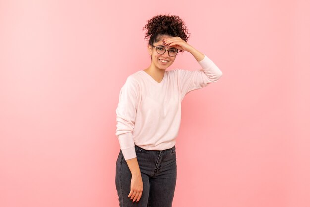 Front view of pretty female smiling on pink