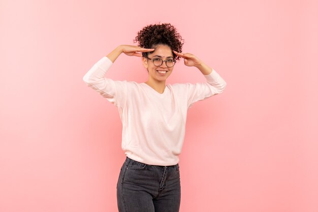 Front view of pretty female smiling on pink