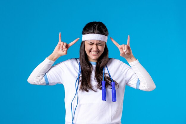 Front view pretty female in sport clothes with skipping rope