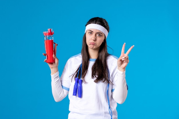 Front view pretty female in sport clothes with skipping rope