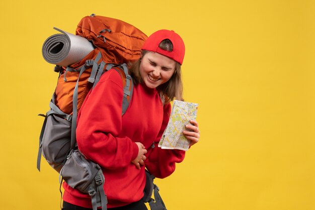 Front view pretty female tourist with backpack holding hands with sick stomach