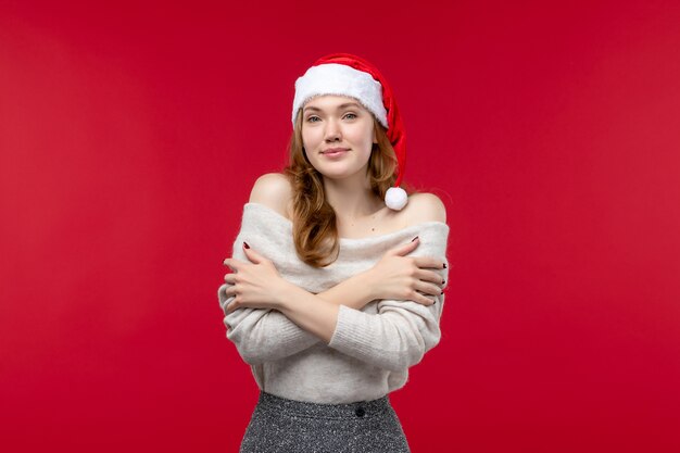 Front view of pretty female with delighted expression on red