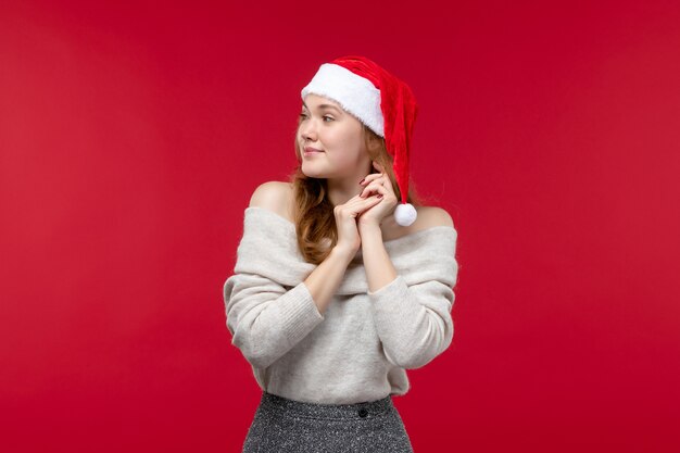 Front view of pretty female with delighted expression on red