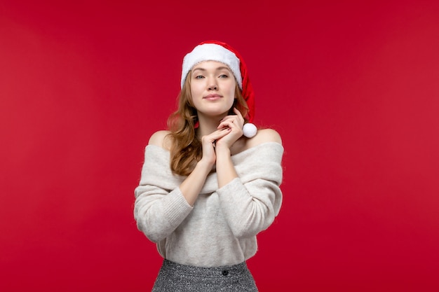 Front view of pretty female with delighted expression on red