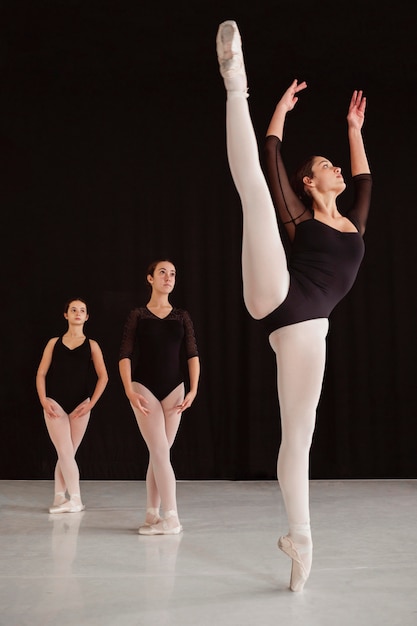 Front view of professional ballet dancers practicing together