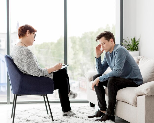 Front view of psychologist consulting a patient