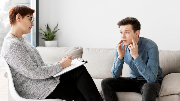 Free photo front view of psychologist and patient