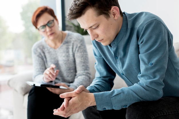 Free photo front view of psychologist and patient