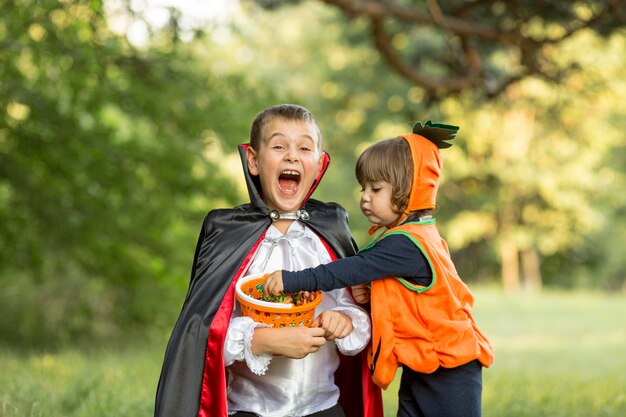 Front view of pumpkin and dracula halloween costumes