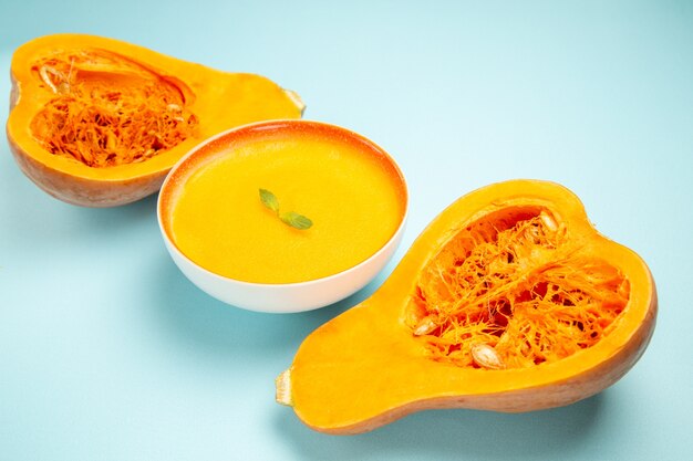 Front view pumpkin soup with fresh pumpkins on blue table dish color soup