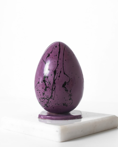 Front view purple black egg designed on the white floor