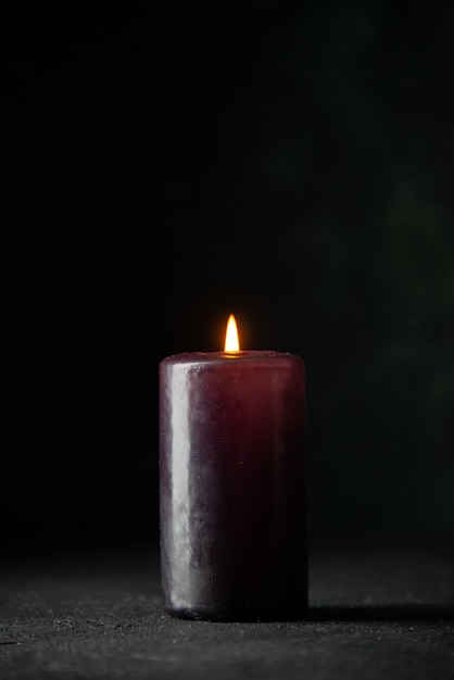 Free photo front view of purple candle on dark