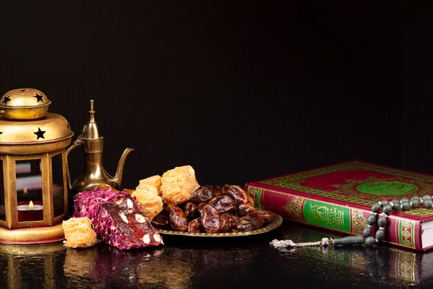 Front view quran beside pastries 