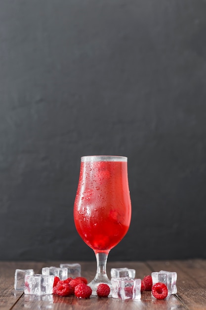Front view of raspberry cocktail with ice cubes