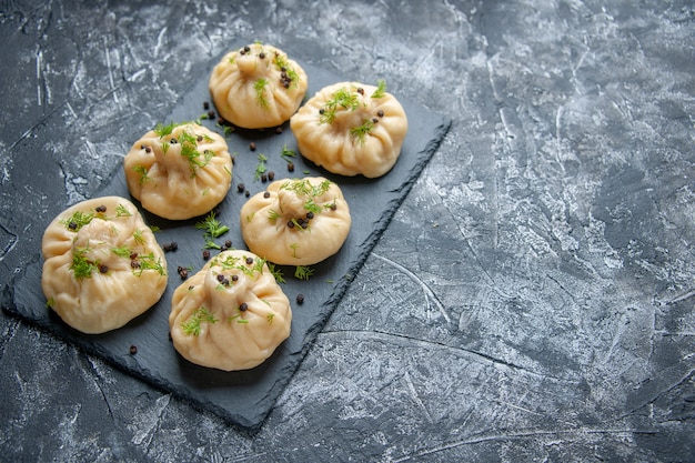 Front view raw dumplings little dough pieces on gray background cuisine dish cake dinner meal dough cooking meat