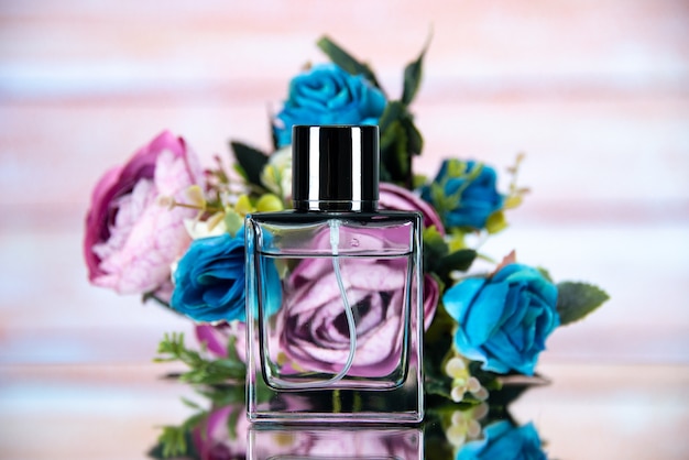 Front view of rectangle perfume bottle colored flowers on beige blurred