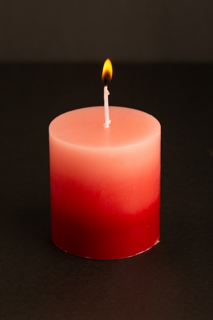 A front view red candle lighting isolated melting light fire flame