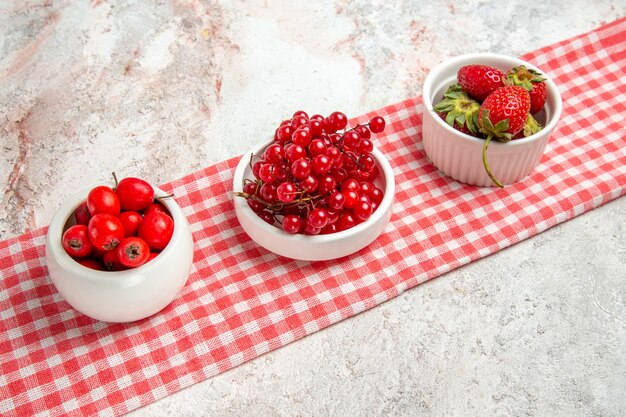 Вид спереди красные фрукты с ягодами на белом столе свежие красные ягоды фруктов