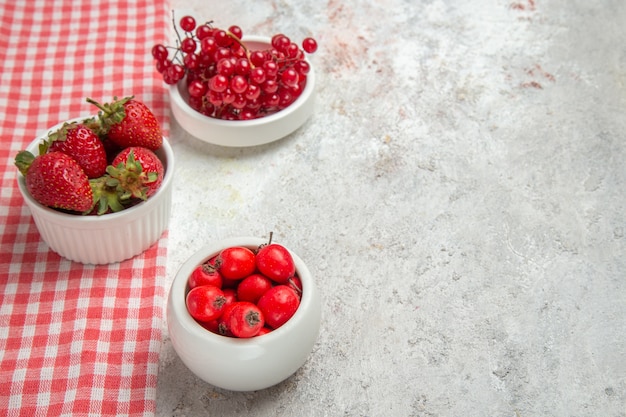 Front view red fruits with berries on white table berry fresh fruit