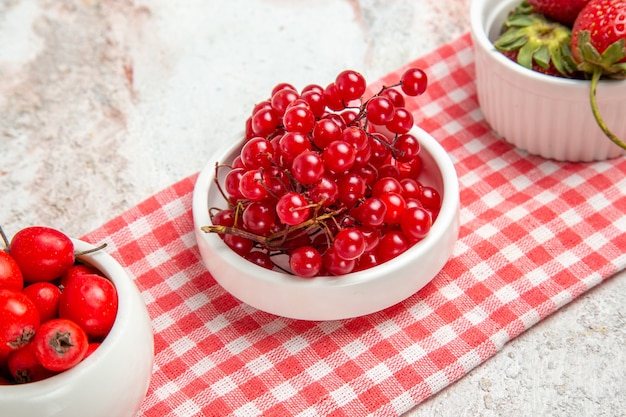 Front view red fruits with berries on a white table fresh red fruits berry