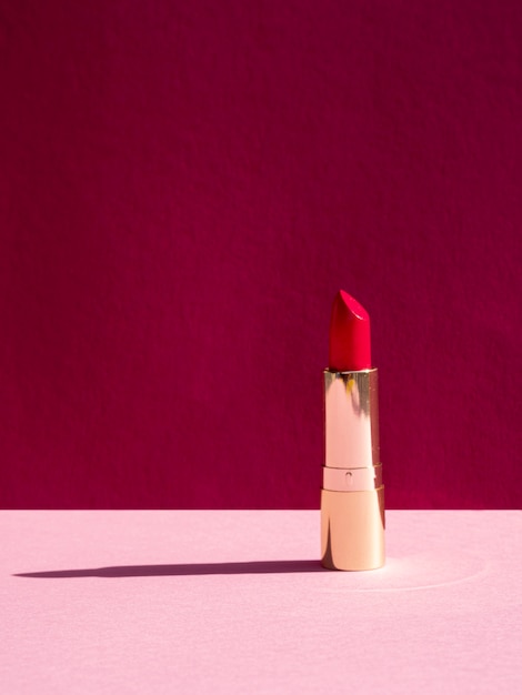 Front view red lipstick on pink background