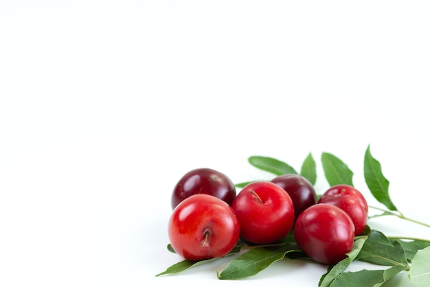 Free photo a front view red plums mellow and sour on white desk