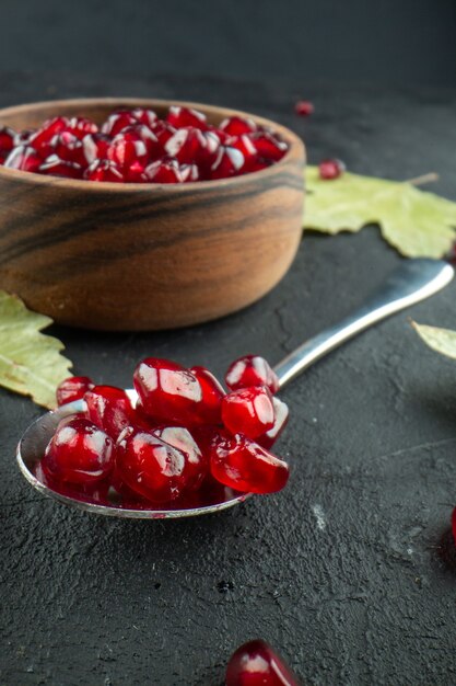 Front view red pomegranates peeled on grey fruits color photo tree