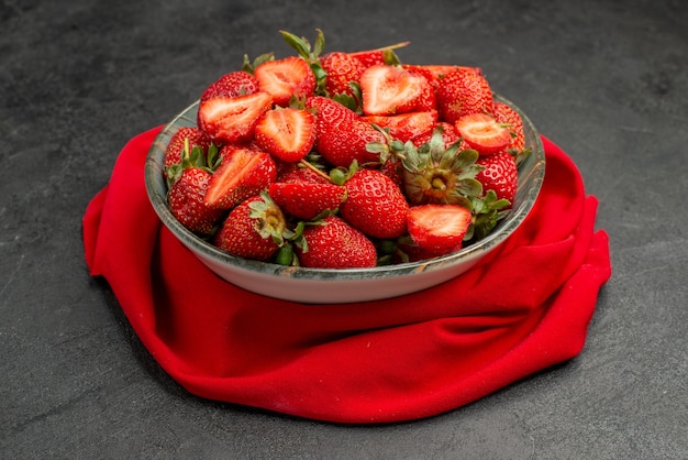 Front view red strawberries inside plate on dark background summer color juice berry wild