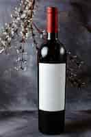 Free photo front view red wine bottle on the grey surface