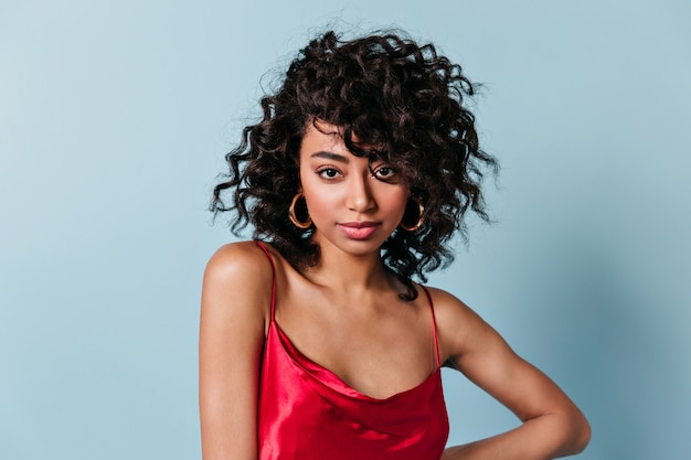 Front view of refined woman with black curly hair