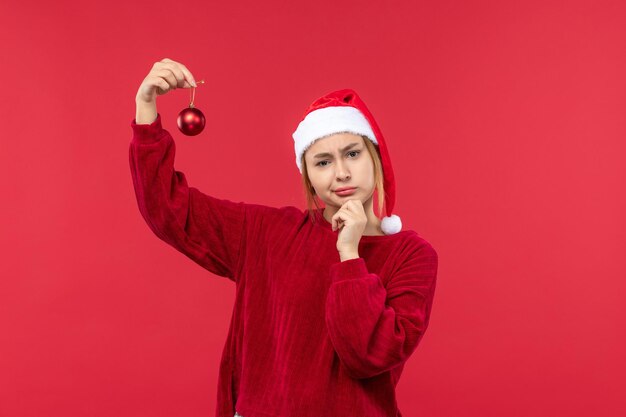 Front view regular female holding christmas toy, christmas red holidays