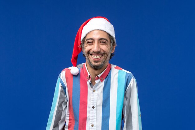 Front view regular man with red christmas cap, color holiday male emotion