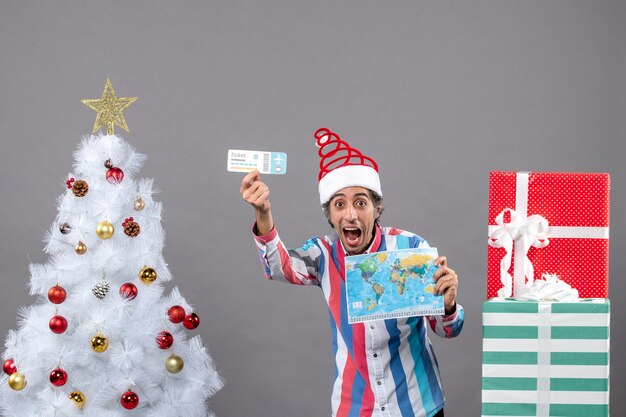 Front view rejoiced man holding map and travel ticket