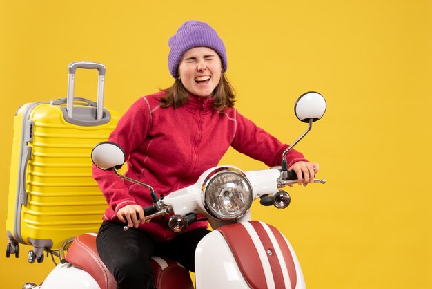 Front view rejoiced young girl on moped feeling ready to move